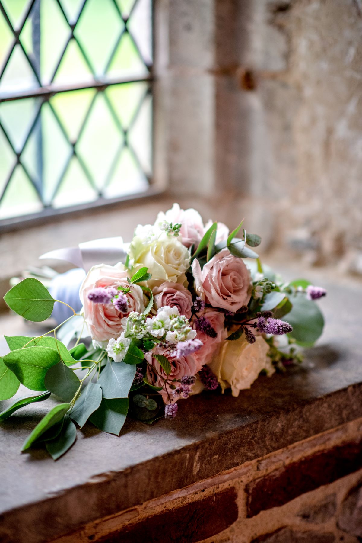bridal bouquet on a castle windowsill