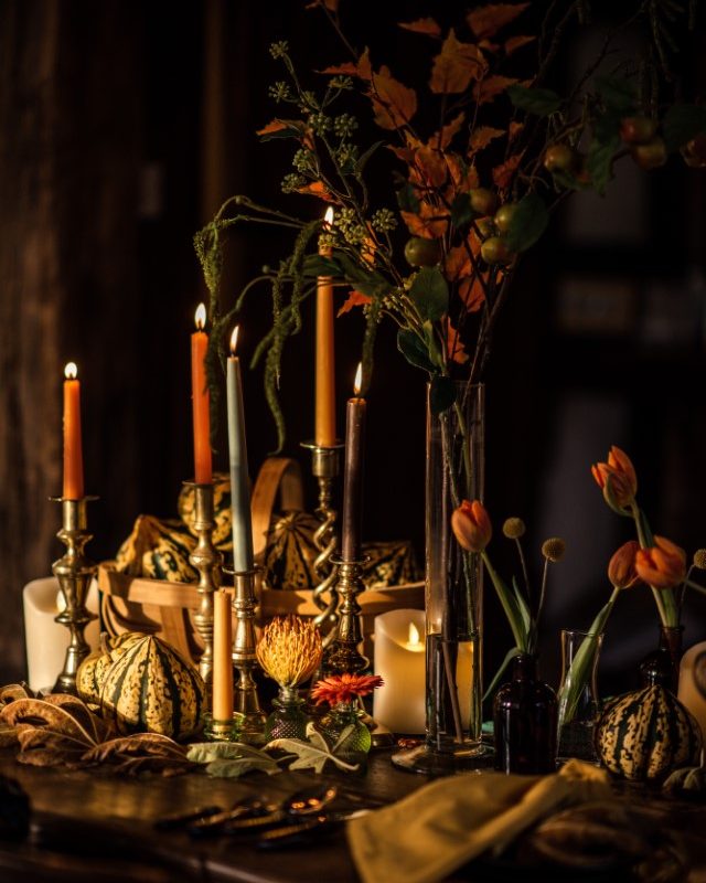 Lit candles with pumpkins