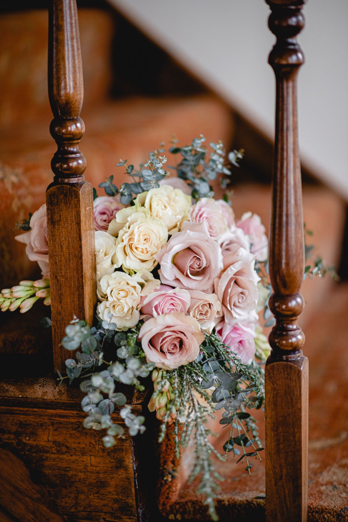 A pink bouquet on carpeted stairs